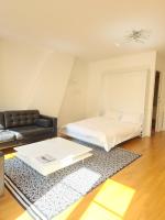 a living room with a bed and a coffee table at Rue François Miron in Paris