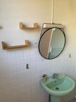 a bathroom with a mirror and a sink at Télétravail et Plaisir au soleil avec vue mer! in Bouillante