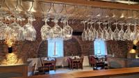 a dining room with glasses hanging from the ceiling at Resort Nová Včelnice in Nová Včelnice