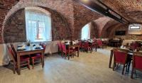 a restaurant with tables and chairs in a brick wall at Resort Nová Včelnice in Nová Včelnice