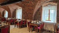 a restaurant with brick walls and tables and chairs at Resort Nová Včelnice in Nová Včelnice
