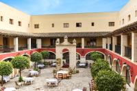 a courtyard with tables and chairs in a building at ALEGRIA Bodega Real in El Puerto de Santa María