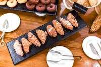 a table with a tray of sausages and pretzels at ALEGRIA Bodega Real in El Puerto de Santa María