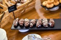 a tray of chocolate covered donuts on a table at ALEGRIA Bodega Real in El Puerto de Santa María