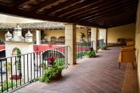 a porch of a house with a fence and flowers at ALEGRIA Bodega Real in El Puerto de Santa María