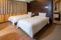 two beds in a hotel room with a bathroom at CHECK inn Express Taichung Fengchia in Taichung