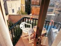 a balcony with a table and a white chair at Double bedroom with shared bathroom, NO KITCHEN in Msida