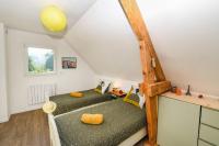 a room with two bunk beds in a attic at Maison Mélèry in Saint-Pierre-du-Val