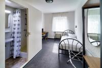 a small room with a bed and a bathroom at Hotel Tanne in Saalfeld