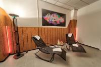 a waiting room with two chairs and a tv at Hotel Tanne in Saalfeld