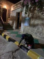 a man is working on a curb in front of a building at apartment between ajloun castle and Jerash ruins in Jerash