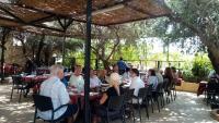 a group of people sitting at tables under a pergola at apartment between ajloun castle and Jerash ruins in Jerash
