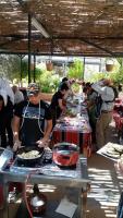 a group of people standing around a table with food at apartment between ajloun castle and Jerash ruins in Jerash