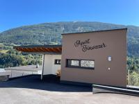 a building with a mountain in the background at Apart Finazzer in Wenns