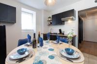 a kitchen with a table with blue bowls and wine bottles at Le Sans Souci @Chique@Moderne@Proche du centre-ville 3pieces 2 Chambres in Colmar