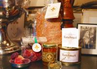 a table topped with jars of jam and berries at Tertin Kartano in Mikkeli