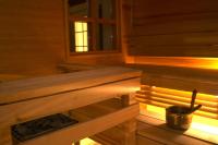 a wooden sauna with a bench and a window at Tertin Kartano in Mikkeli
