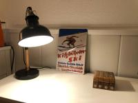 a lamp on a table with a book and a box at Bleuets II in Sainte-Léocadie
