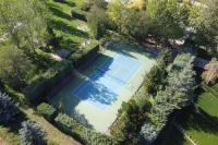 an overhead view of a swimming pool with a tennis court at Bleuets II in Sainte-Léocadie