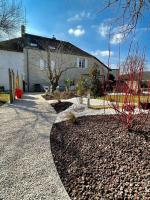 a house with a building and a gravel driveway at Bienvenue au Gite La So Sweet in Rully