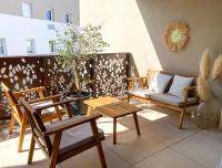 a patio with chairs and a table and a couch at Appartement terrasse proche Centre in Montpellier