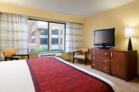 a hotel room with a bed and a flat screen tv at Courtyard by Marriott Birmingham Downtown at UAB in Birmingham