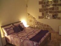 A bed or beds in a room at La Grotta