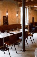 een eetkamer met tafels en stoelen met wijnglazen bij La Planque en Perche in Bellou-le-Trichard