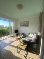 a living room with a couch and a table at Chris&#39;Home2 in Roquebrune-Cap-Martin