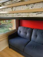 a couch in a room with a loft bed at STUDIO AVEC TERRASSE DONNANT SUR UN PARC ABORE in Bourg-en-Bresse