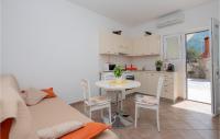 a living room with a table and a kitchen at Cozy Home In Makarska With Kitchen in Makarska