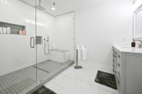 ein weißes Badezimmer mit Dusche und Waschbecken in der Unterkunft Spacious+Cozy Home, near the beach, heated pool. in Naples