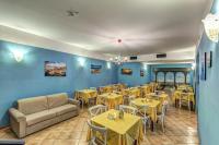 a restaurant with tables and chairs and a couch at Hotel Nice in Sorrento