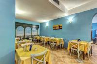 a dining room with yellow tables and chairs at Hotel Nice in Sorrento