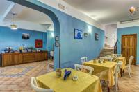 a restaurant with tables and chairs and blue walls at Hotel Nice in Sorrento