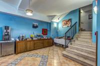 a lobby with blue walls and stairs and a counter at Hotel Nice in Sorrento