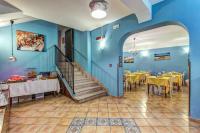 a restaurant with blue walls and tables and a staircase at Hotel Nice in Sorrento