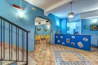 a blue room with a staircase and a dining room at Hotel Nice in Sorrento