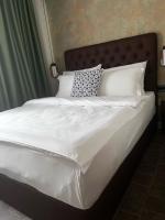 a large white bed with white sheets and pillows at Vlasinsko jezero VILA BEST in Surdulica