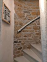 a stone wall and stairs with a picture on the wall at Le 1 St Yves Studios in Tréguier