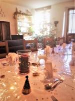 a table with wine glasses and a christmas tree at Chez Providence Chambres et Table d'Hôtes in Cuxac-Cabardès