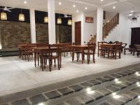 a dining room with wooden tables and chairs at PearlDrop Waves Mirissa in Mirissa