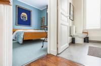 a bedroom with a bed and a toilet in it at Maison confortable avec jardin à 2 pas de Paris in Fontenay-sous-Bois