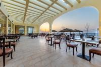 a restaurant with tables and chairs and a view of the ocean at Siva Golden Bay Makadi in Hurghada