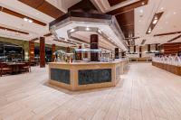 a restaurant with a bar in the middle of a room at Siva Golden Bay Makadi in Hurghada