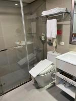a bathroom with a shower and a toilet and a sink at Hub Hotel Kaohsiung Cisian Branch in Kaohsiung