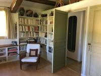 a room with a book shelf filled with books at 06AW - Mas en pierre provençal rénové au calme in Le Rouret