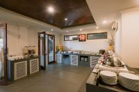 a kitchen with a counter with plates on it at Ombak Sunset in Gili Trawangan