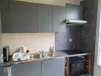 a kitchen with gray cabinets and a sink at Appartement Disney Paris in Serris