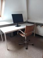 an office desk with a computer monitor and a chair at belle maison in Cormeilles-en-Parisis